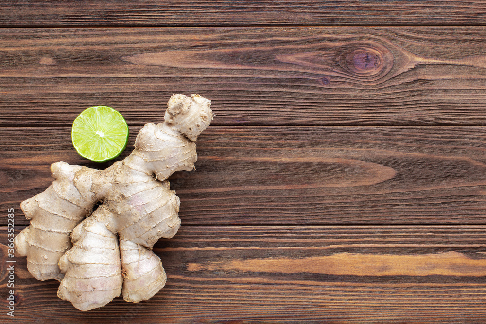 Ginger and lime on wooden background. Top view,copy space