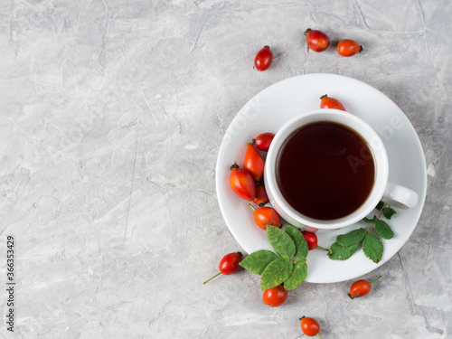 Cup of tea with rosehip berries