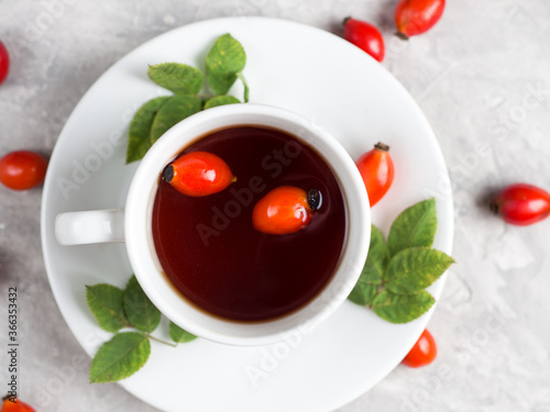 Cup of tea with rosehip berries