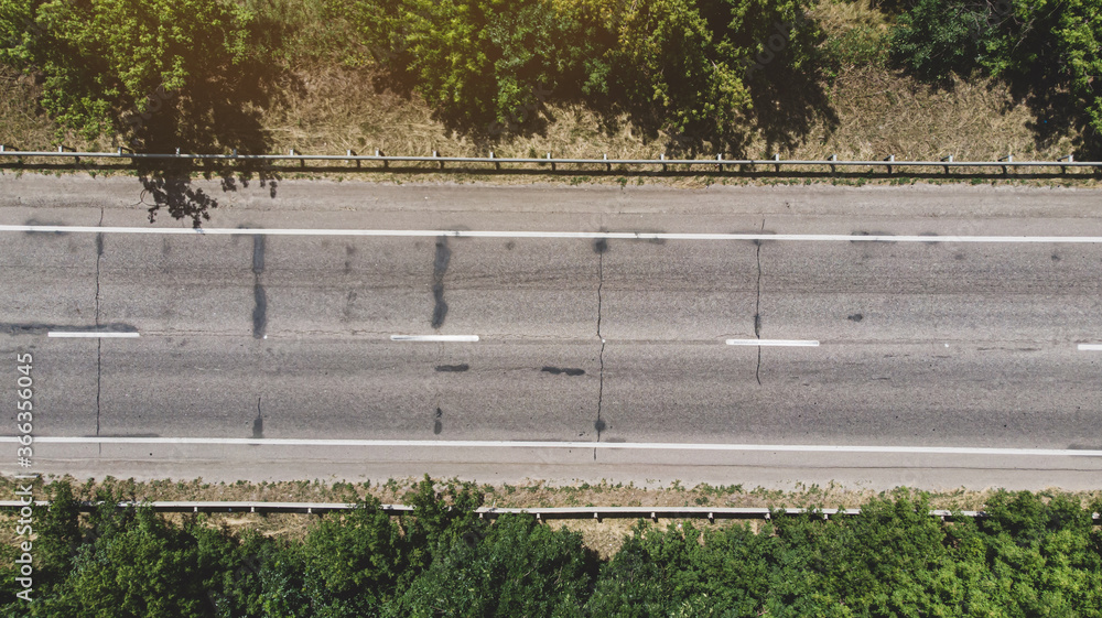 Aerial. Empty cracked asphalt highway road. Top view from drone.