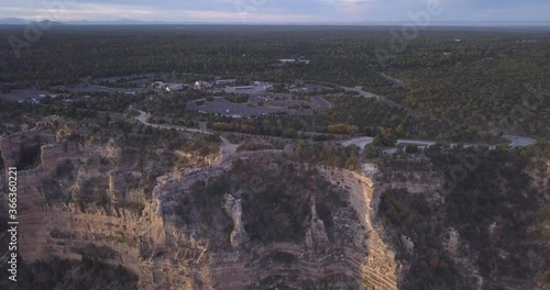 Aerial of Viewpoints in Grand Canyon showing Ledges with people while Forest, parkinglot and Mountain chain shows in Horizon 