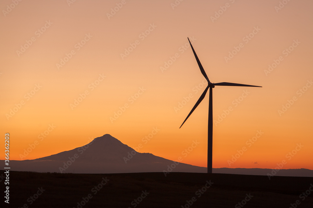 Wind generators in Sherman County Oregon are shown against an orange sunset sky. Located a few miles south of the Columbia River Gorge. Wind generators in Sherman County Oregon are shown against an orange sunset sky. Located a few miles south of the Columbia River Gorge.
