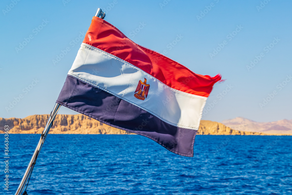 Fototapeta premium Egyptian flag on boat waving over the red sea