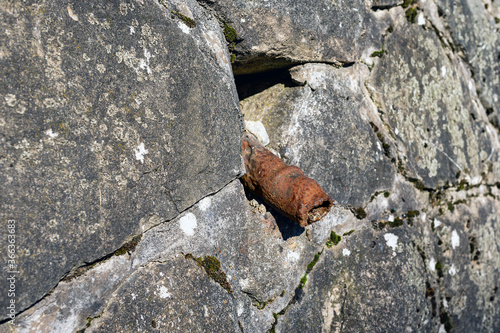 An old rusty pipe. Impotence, genital diseases in men concept. photo