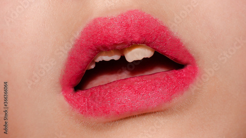Baby lips with fluffy lipstick. Children's teeth.