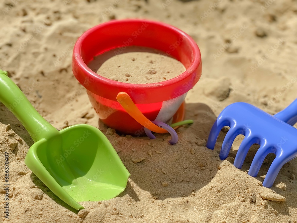 Toys shovel, rake and bucket for children's sandbox. Children's toys. Toys shovel, rake and bucket for children's sandbox. Children's toys.
