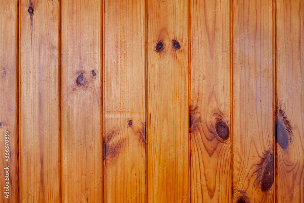 Fototapeta premium varnished wood wall from vertical planks. Background texture. Close up.