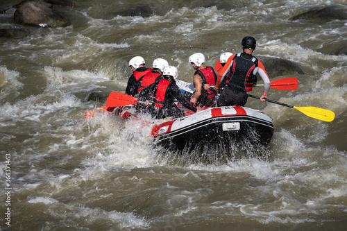 Close up of a boat with a team practicing rafting in swirling waters