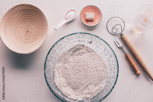 bread-making tools. Bread ingredients flour, salt, water and banneton