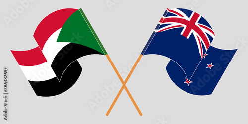 Crossed and waving flags of Sudan and New Zealand