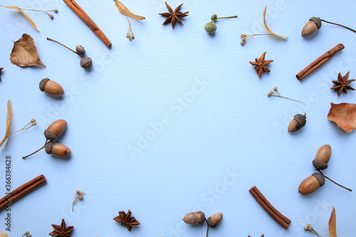 Hello autumn. Fall background made of dried yellow leaves and acorns with copy space. Seasonal composition, fall, thanksgiving day concept. Flat lay, top view