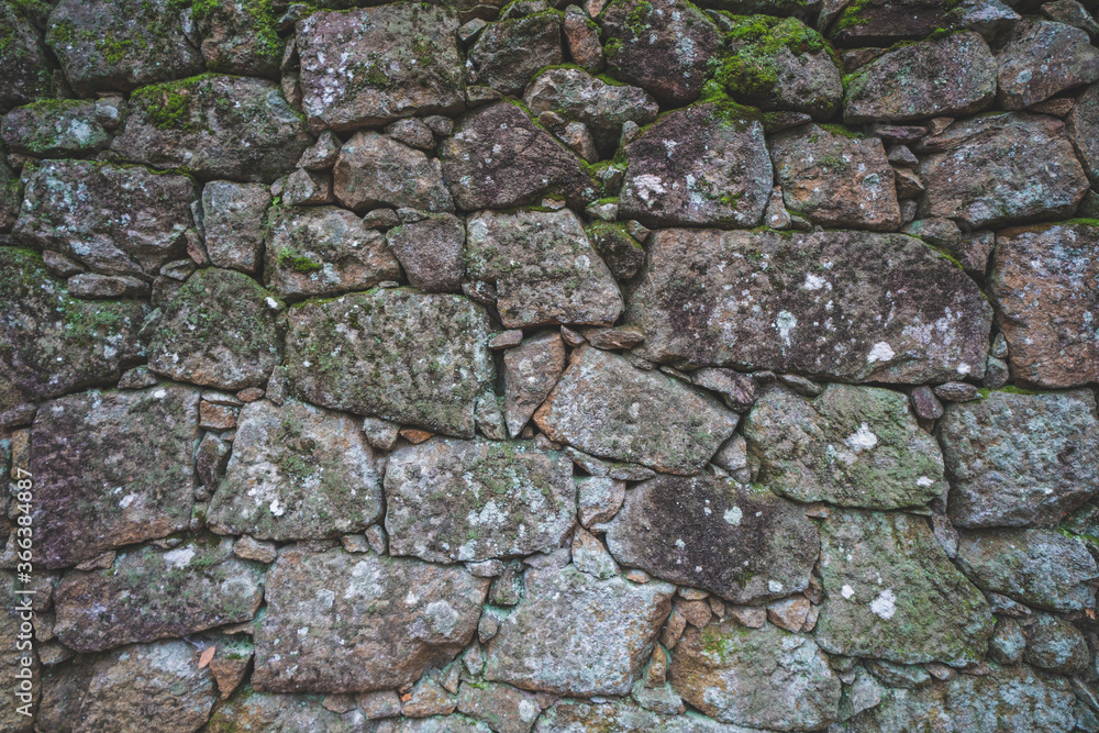 Old real stone wall surface texture. Pattern white, yellow modern style design decorative uneven cracked rocks. Old real stone wall surface texture. Pattern white, yellow modern style design decorative uneven cracked rocks.