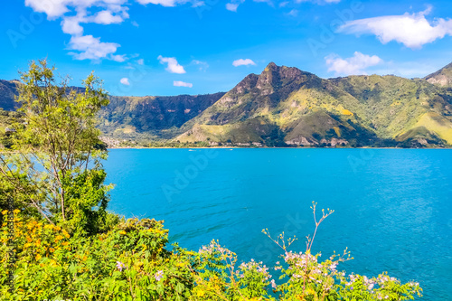 Blue Lake Atitlan surrounded by Volcanoes in Guatemala photo