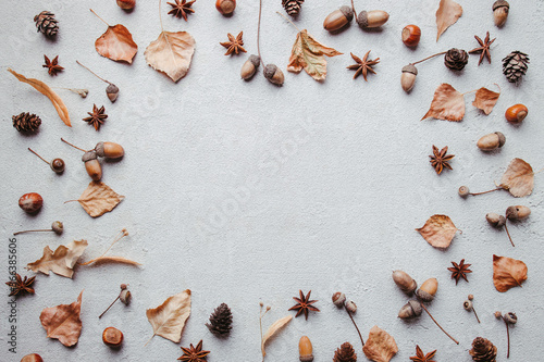 Hello autumn. Fall background made of dried yellow leaves and acorns with copy space. Seasonal composition, fall, thanksgiving day concept. Flat lay, top view