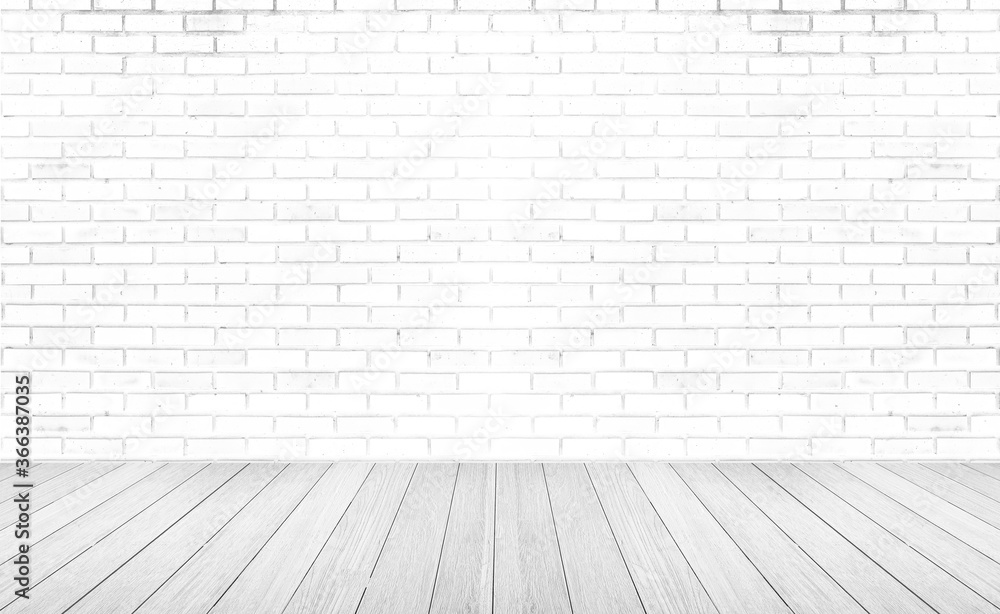 Empty room with grey wooden floor with brick wall background. Studio or office blank space.