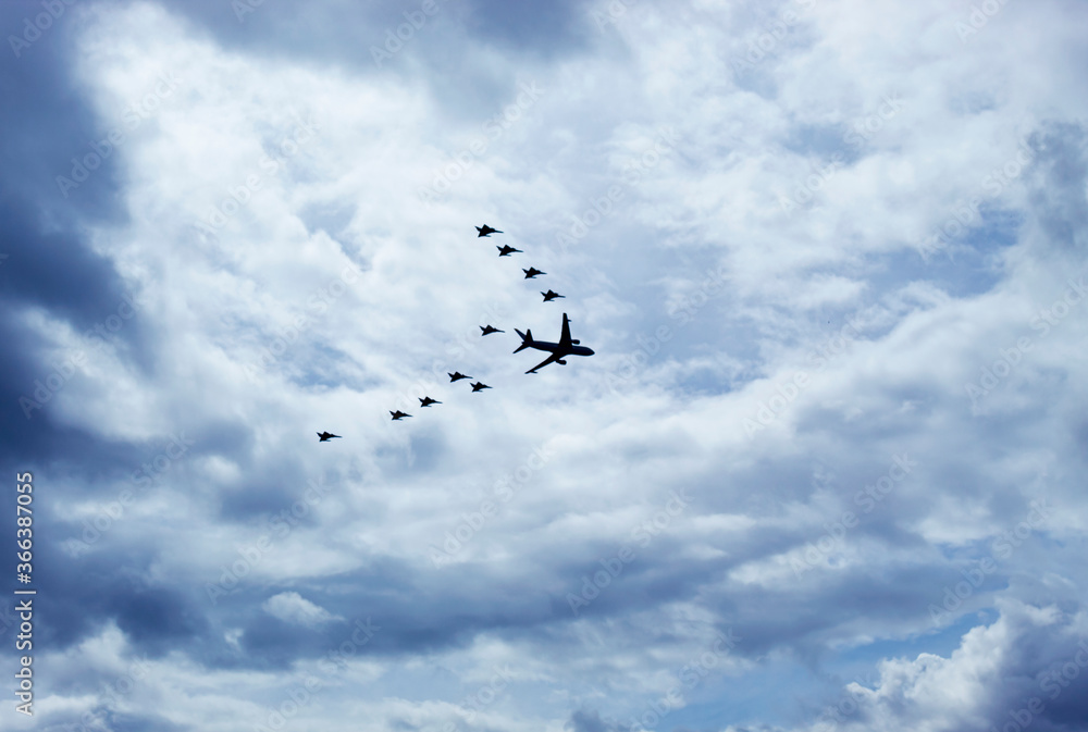 Military airplanes flying in V formation with blue sky and cloudy day at background. Military and aircraft concept Military airplanes flying in V formation with blue sky and cloudy day at background. Military and aircraft concept