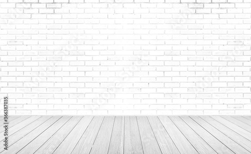 Empty room with grey wooden floor with brick wall background. Studio or office blank space.
