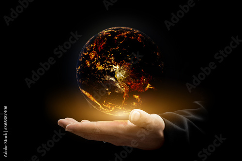Environment concept. Earth with light in hands on black background. Elements of this image furnished by NASA