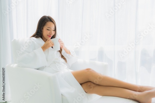 Portrait beautiful young asian woman relax happy smile with coffee cup on sofa