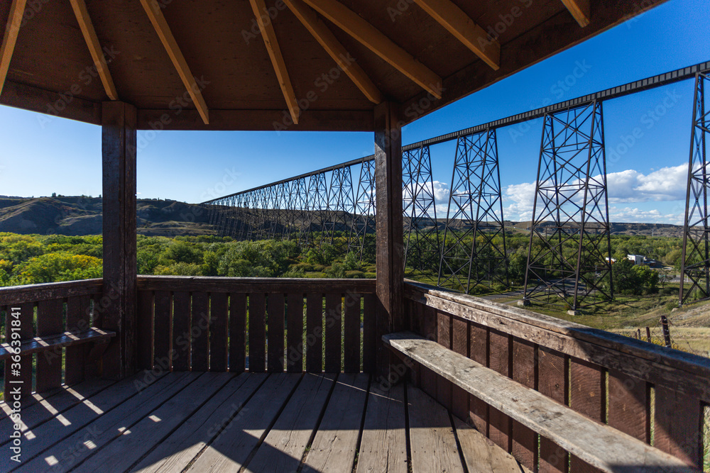 view of a super tall and long steel bridge in summer with blue sky from a platform