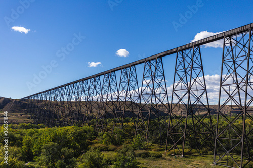 view of a super tall and long steel bridge in summer with blue sky
