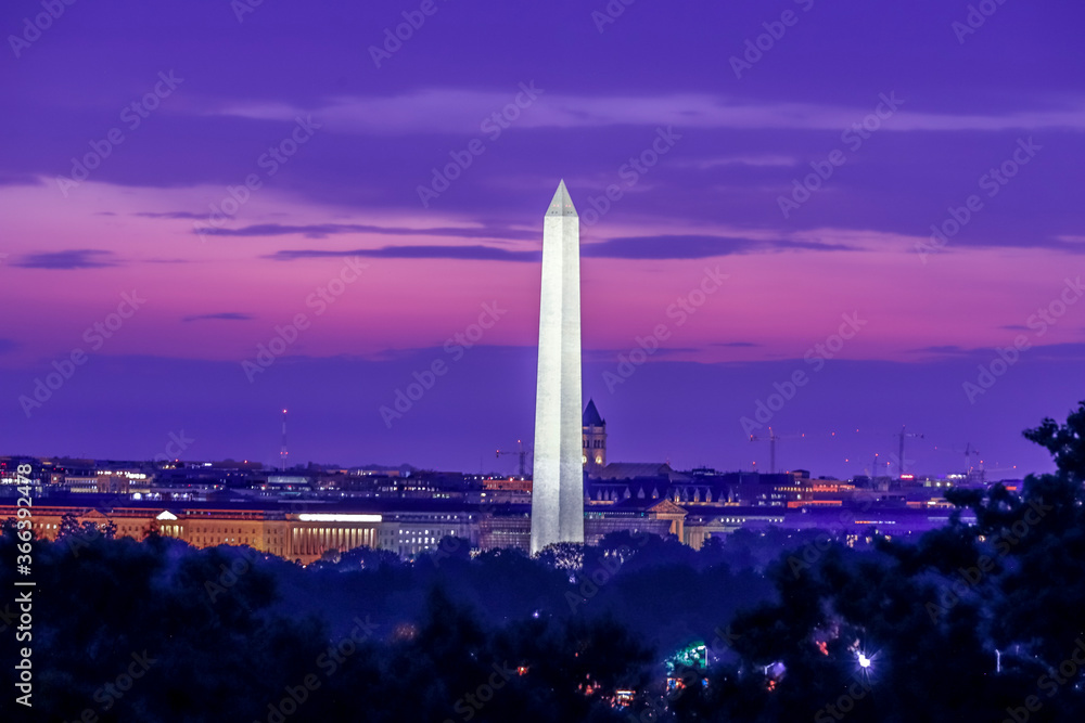 Washington Monument at sunrise with orange and purple clouds in the background Washington DC, USA