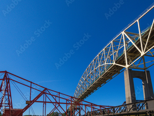 two steel suspension bridges in summer on a bright summer day