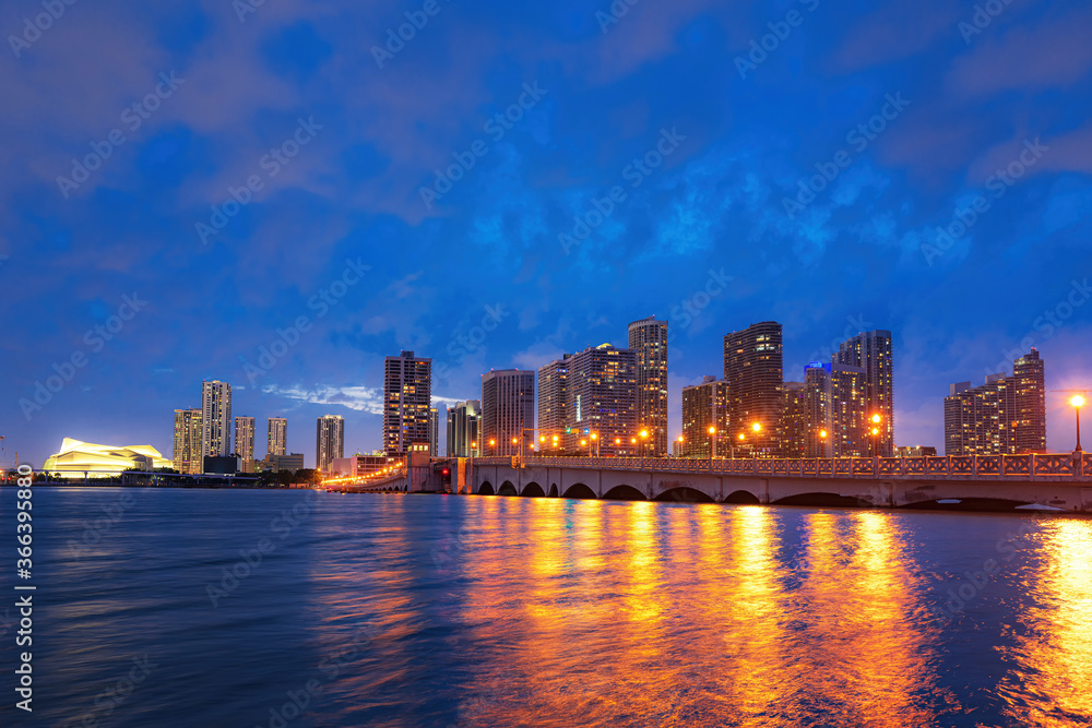 City of Miami Florida skyline and bay with night clouds. Miami city night.