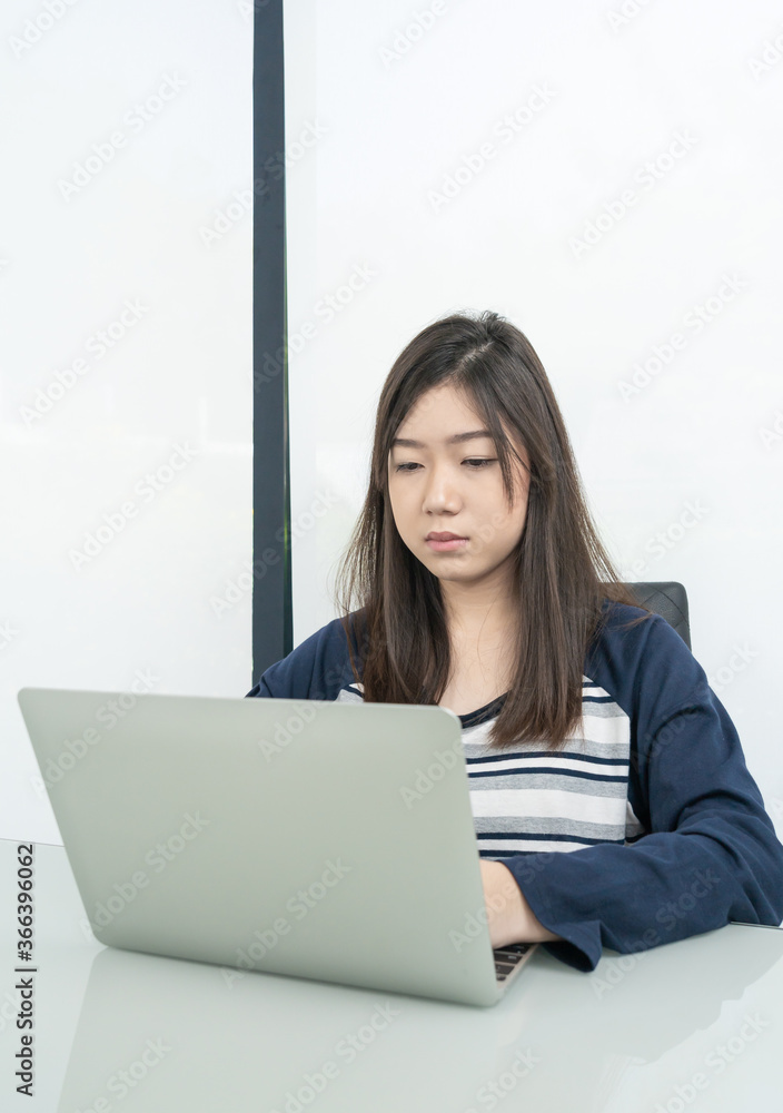 Young female student sitting in living room and learning online Young female student sitting in living room and learning online