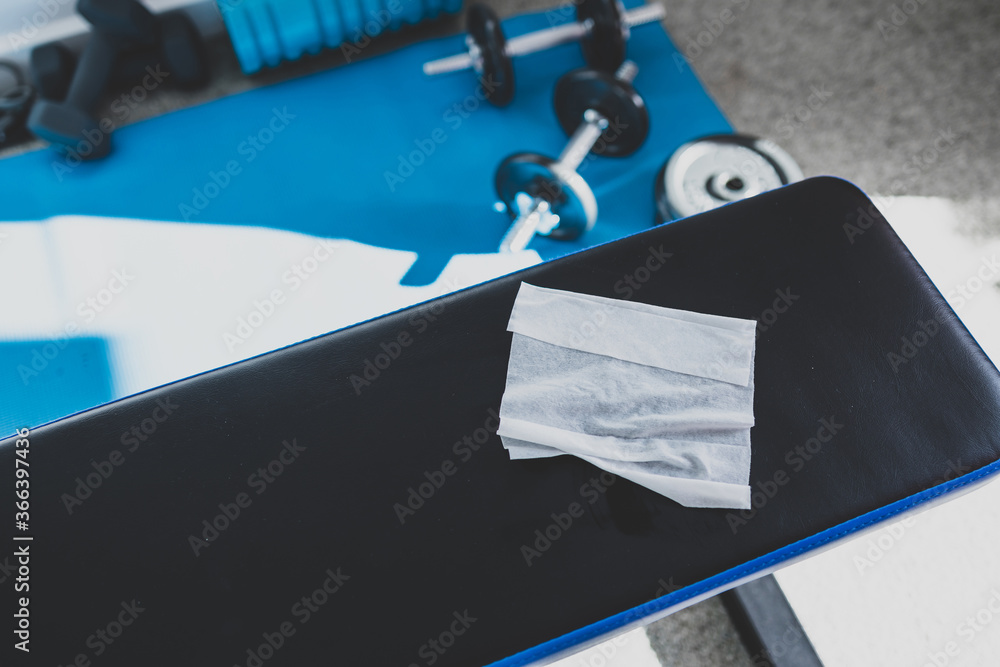 the new normal after covid19, hand cleaning gym equipment with