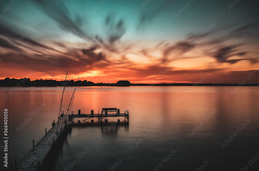 Long exposure sunset on a lake with a dock