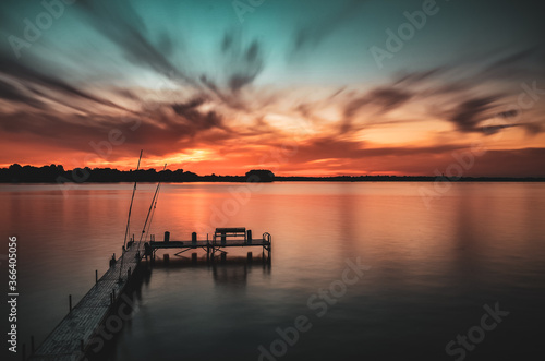 Fototapeta Naklejka Na Ścianę i Meble -  Long exposure sunset on a lake with a dock