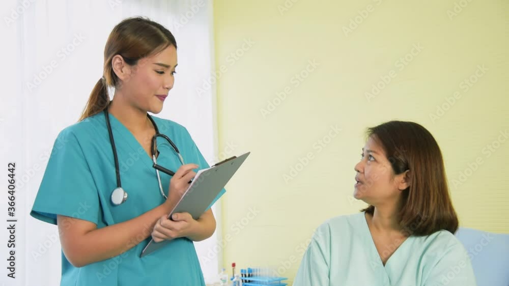 Professional doctor in work coat uniform wearing talking and recording symptom from the elder patient illness at hospital Professional doctor in work coat uniform wearing talking and recording symptom from the elder patient illness at hospital