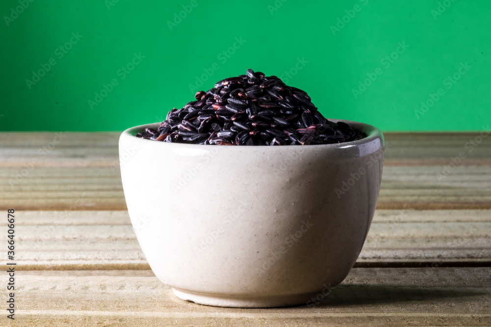 black venus rice on glass bowl isolated on wooden table in Brazil black venus rice on glass bowl isolated on wooden table in Brazil