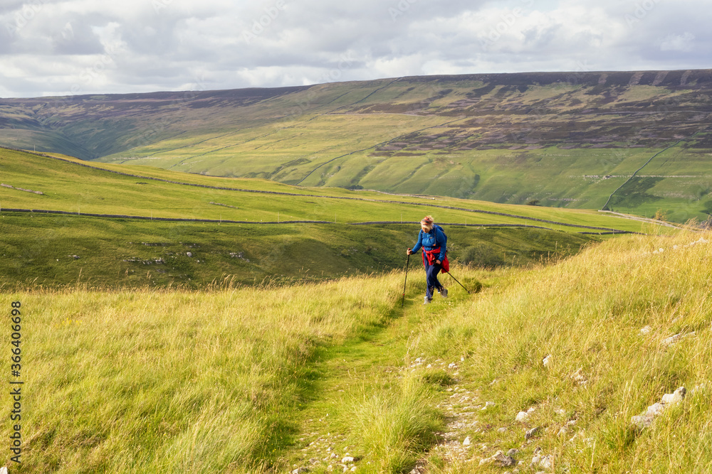 Female hill walker on the monks trail from Arncliffe to Malham Tarn in the yorkshire Dales