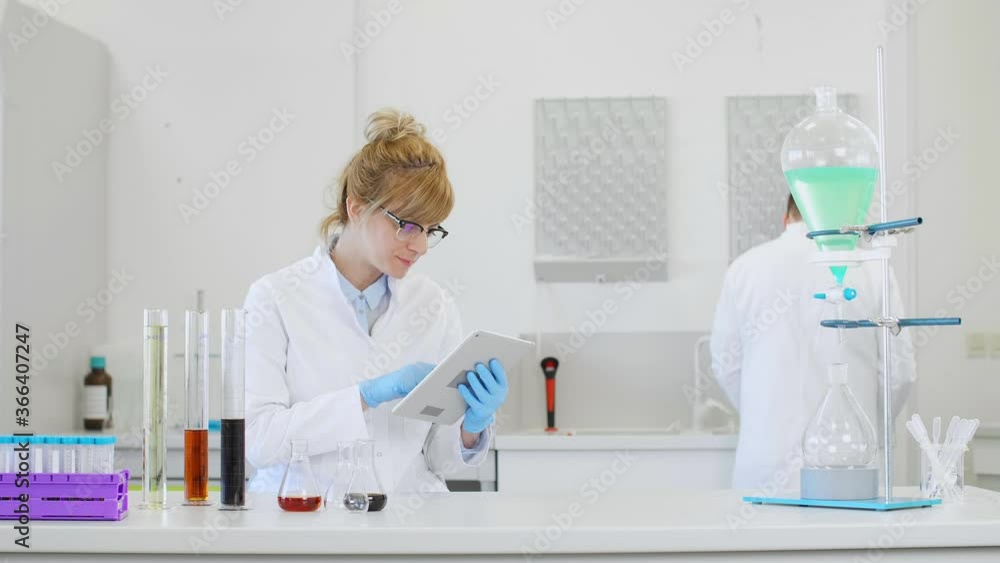 Chemist working with hemp CBD oil and tablet in laboratory Chemist working with hemp CBD oil and tablet in laboratory