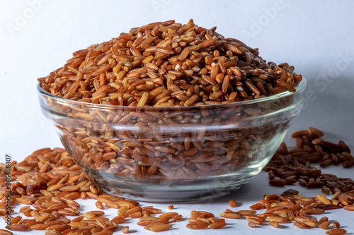 red integral rice on glass bowl isolated on white background in Brazil
