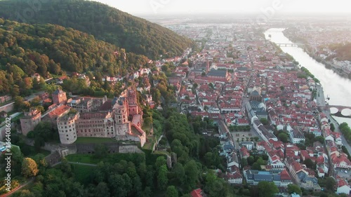 Aerial Drone Shot of Heidelberg, Germany with the famous heidelberg palace in the front of the frame while sunset
