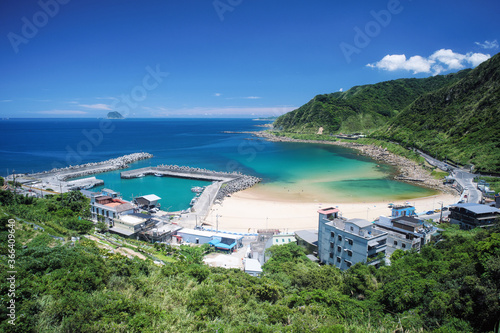 Coast Landscape - Dawulun Fishing Harbor and Dawulun Sandy Seashore with afternoon blue bright sky, shot from Mt. Waimu Shan (Waimushan) Observation Deck in Anle District, Keelung, Taiwan.