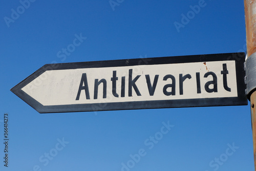 Swedish signpost with direction to a antiquarian.