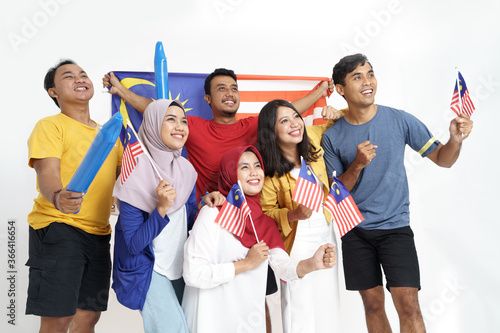 excited asian young supporter holding malaysia flag over white background