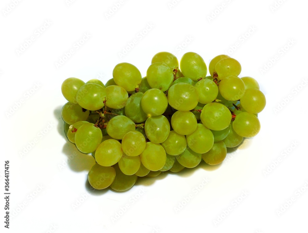A bunch of green raisins raisins on a white background A bunch of green raisins raisins on a white background