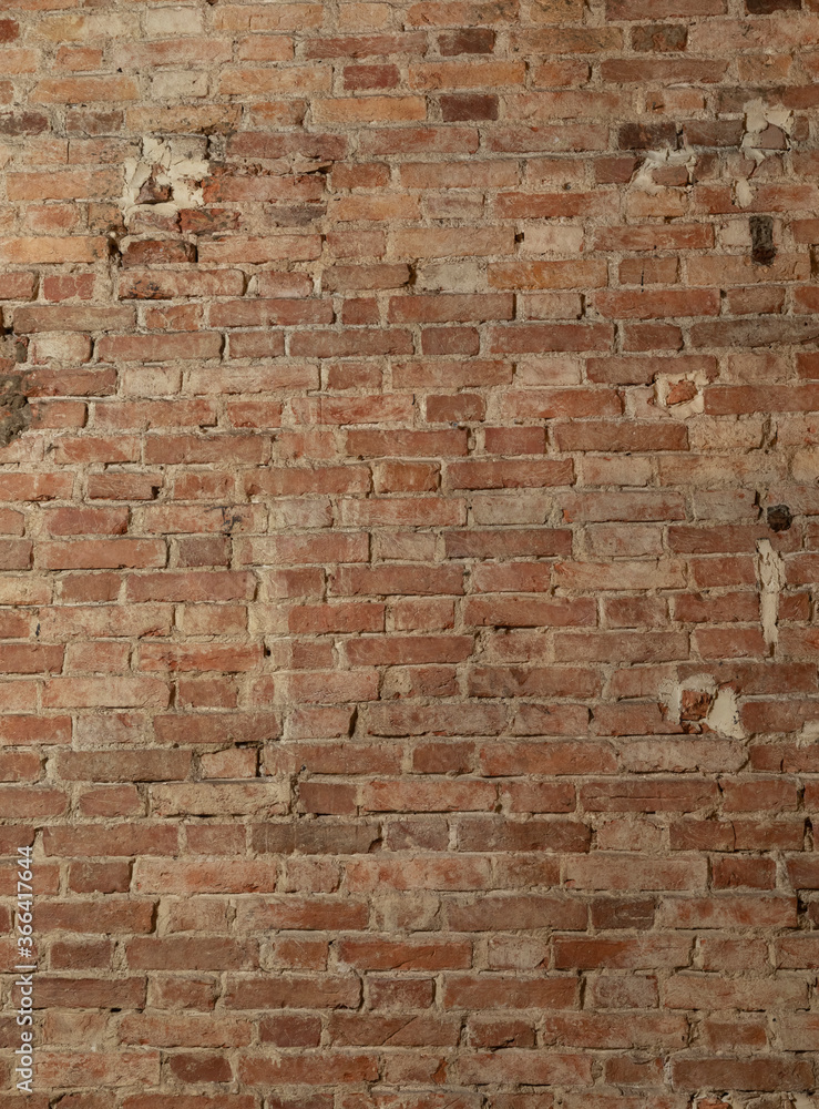 Naklejka premium ancient brick wall in chic apartment vertical orienration