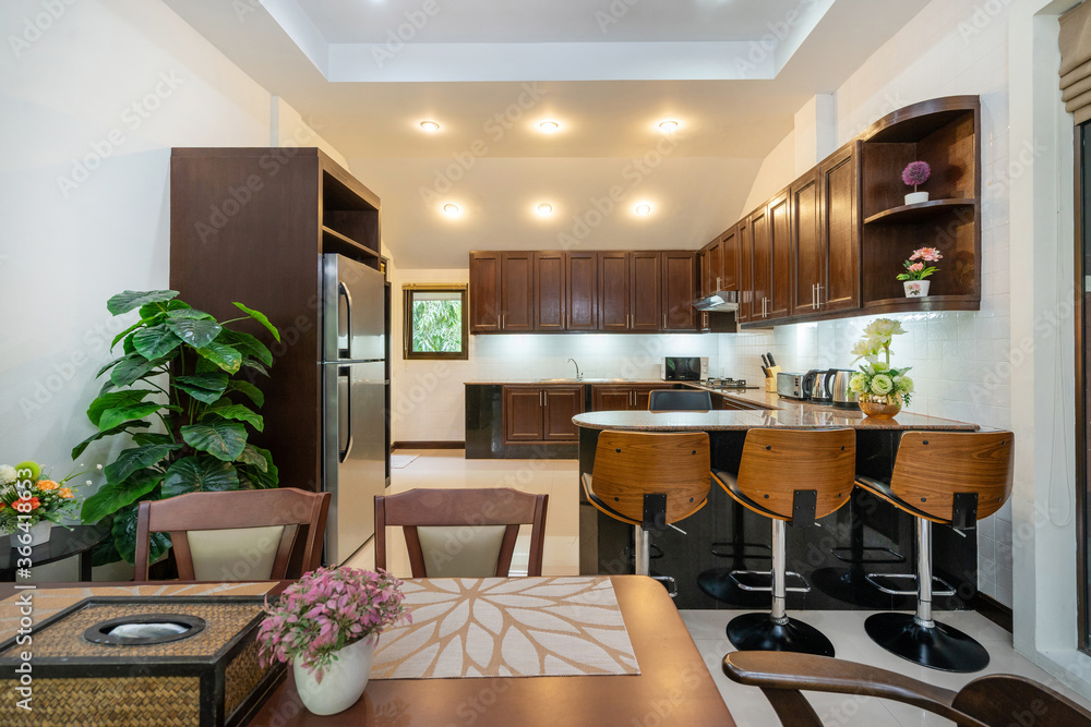 Interior design of house, home, villa and apartment feature refrigerator, stool, kitchen counter, ceiling fan, shelf and dining table. Interior design of house, home, villa and apartment feature refrigerator, stool, kitchen counter, ceiling fan, shelf and dining table.
