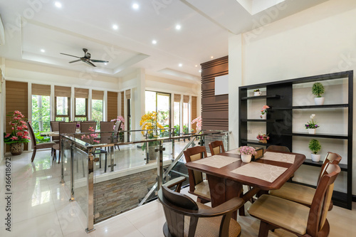 Interior design of house  home and villa feature dining table  dining chair and yellow artificial flower in big pot.