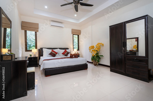 Interior design of house  home  condo and villa feature double bed  red bed runner  and dressing table in bedroom