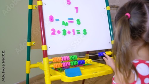 child girl using abacus to learn numbers and account at home