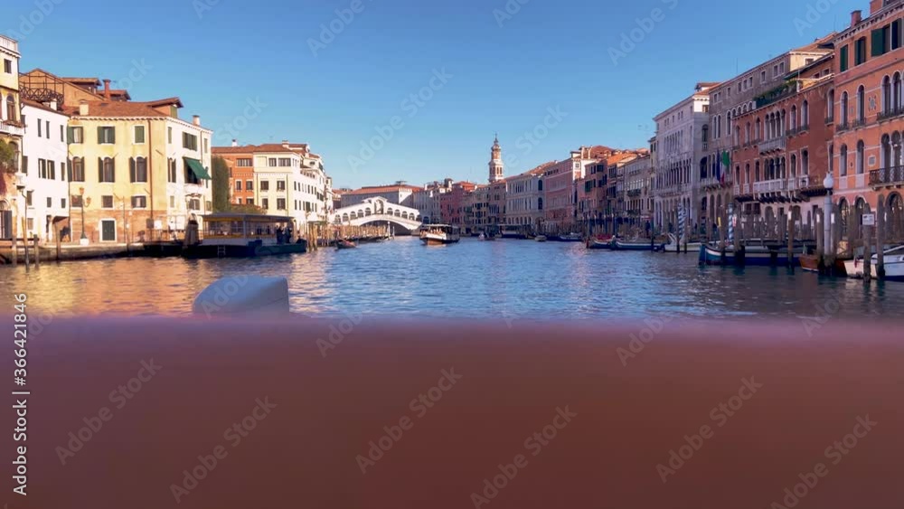 Distant View Of The Rialto Bridge From A Vaporetto Cruising At The Grand Canal In Venice, Italy - wide shot Distant View Of The Rialto Bridge From A Vaporetto Cruising At The Grand Canal In Venice, Italy - wide shot