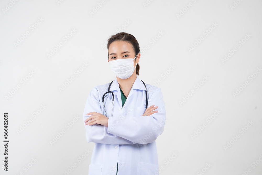 Portrait of an Asian female doctor wearing a medical mask in a medical uniform. Isolated white background Portrait of an Asian female doctor wearing a medical mask in a medical uniform. Isolated white background