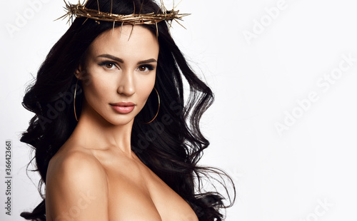 Fotografie Portrait of strong beautiful brunette woman in crown of thorns and dress with de